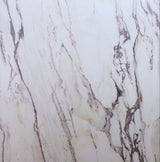 Close-up of marble with beige and brown veins on a white background