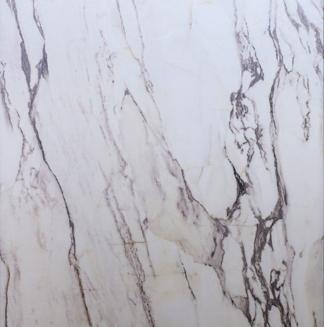 Close-up of marble with beige and brown veins on a white background
